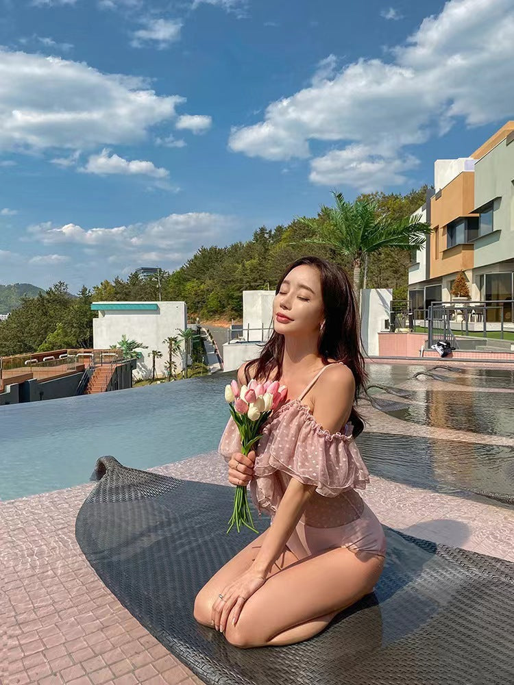 Woman holding tulips sitting by a pool with a scenic background