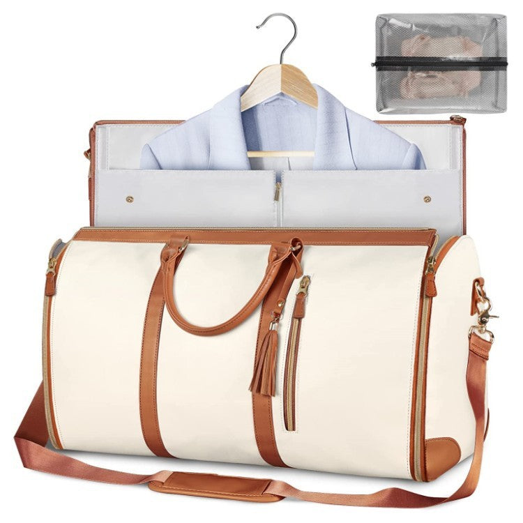 White travel bag with brown straps and a shirt on a hanger, on a white background