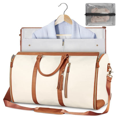 White travel bag with brown straps and a shirt on a hanger, on a white background
