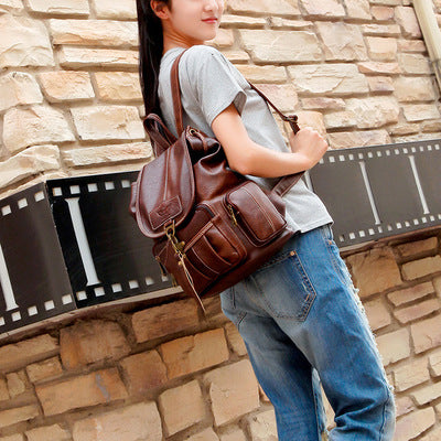 Person wearing a brown leather bag against a stone wall background