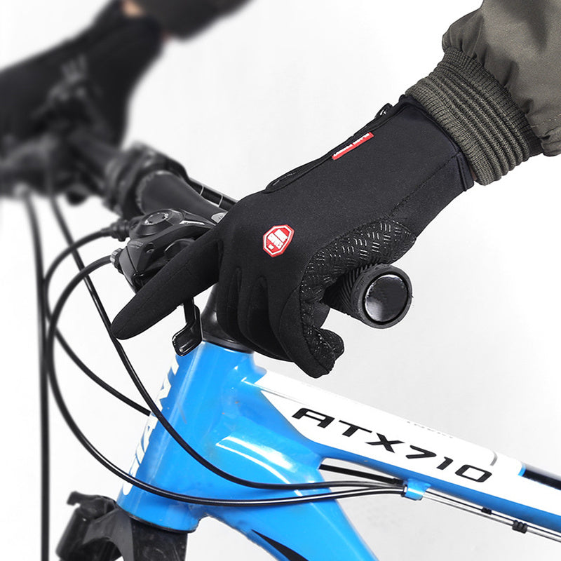 Close-up of a gloved hand on a bicycle handlebar with a blue bike frame labeled 'ATX710'.