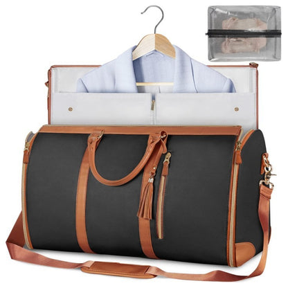 Black duffel bag with brown leather straps and trim, open to reveal clothes and a clear pouch.