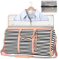 Striped travel bag with pink accents and a shirt on a hanger inside, against a white background.