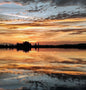 Firstlight on the lake right at the beginning of the golden hour. Serene lake with a beautiful reflection. 