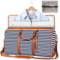 Navy and white striped duffel bag with brown leather straps and trim, containing a shirt and a clear pouch.